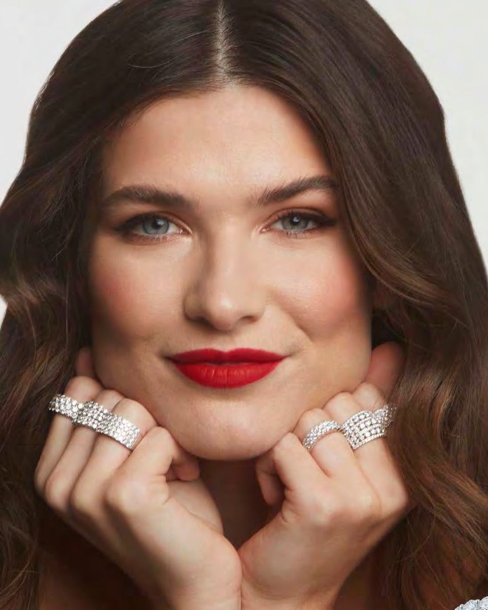 Model wearing lab-grown diamond engagement rings and bands